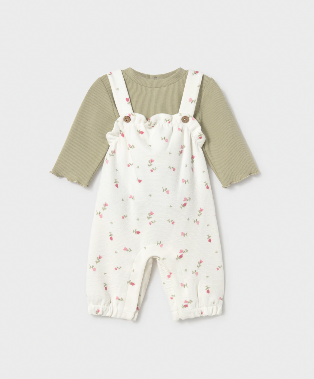 Front view on grey — full set, scalloped bib frill, frilled ankle cuffs, complete silhouette