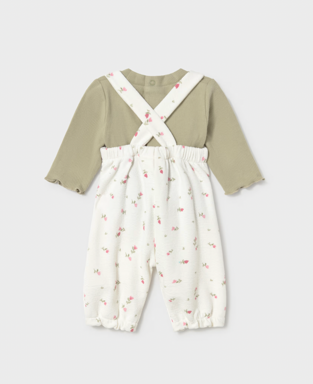 Back view on grey — crossed straps in X, elasticated waist, frilled ankle cuffs, snap button at back neckline