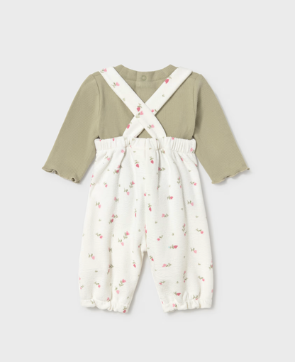 Back view on grey — crossed straps in X, elasticated waist, frilled ankle cuffs, snap button at back neckline