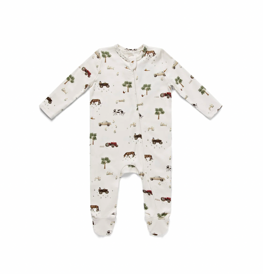  Long-sleeved footed sleepsuit in warm natural oatmeal cream; all-over On The Farm illustrated print: chestnut bay horses, black-and-white Friesian dairy cows, cream vintage Land Rover-style vehicle, dark quad bikes with riders, red tractors, rounded green lollipop trees, white goose or duck, scattered pheasants, wildflower tufts and grass clumps; zip fastening from round neckline to feet; narrow bound neckband in the same print fabric; fully footed design