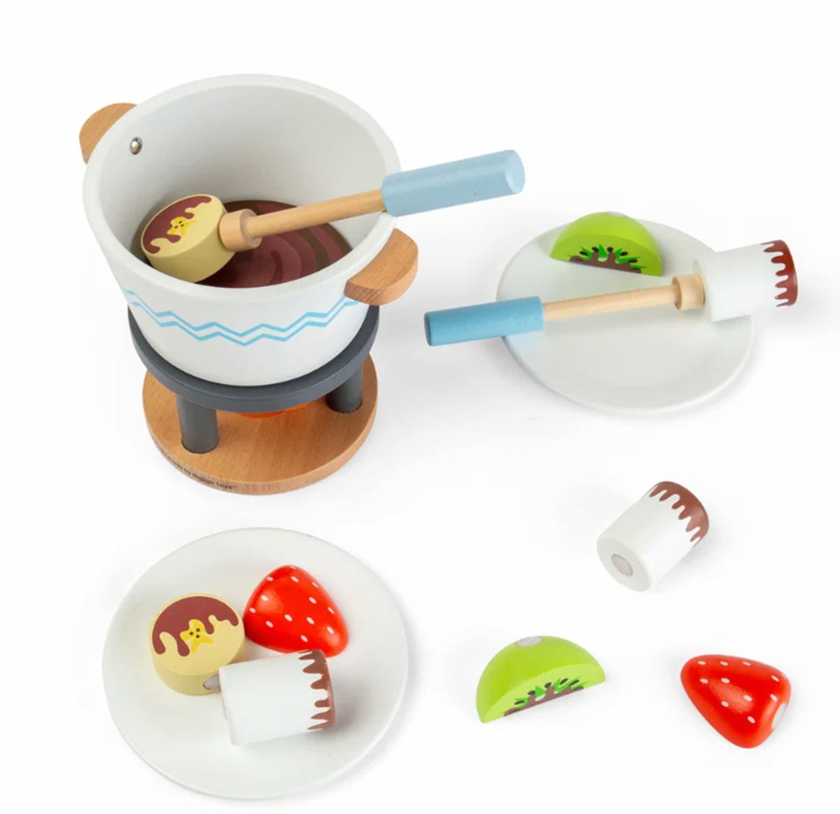 Bigjigs Toys Chocolate Pot for Two on a white background with one dipping stick holding a pale yellow biscuit in the pot; painted orange flame visible on the fire stand below; left plate shows a red strawberry, pale yellow bear-face biscuit and white marshmallow with chocolate drizzle; right plate shows a kiwi slice and a dipping stick; loose strawberry and kiwi pieces to the lower right

