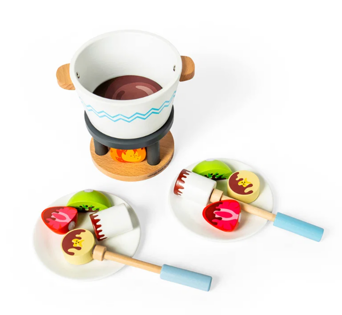 Bigjigs Toys Chocolate Pot for Two set viewed from above on a white background showing the painted dark chocolate-brown interior of the white fondue pot sitting on the dark grey fire stand; two white plates with red strawberry, kiwi slice and bear-face biscuit pieces in the foreground, each with painted chocolate drizzle detail; two sky-blue handled dipping sticks rest beside the plates