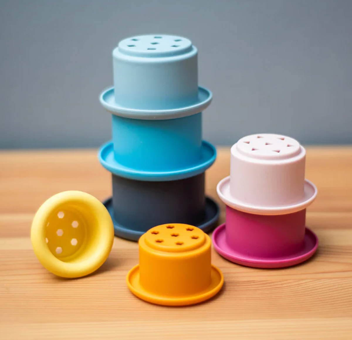 Bigjigs stacking cups activity toy; suitable for children aged 12 months and over and designed for early learning through play