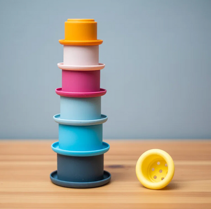 Bigjigs stacking cup toy for children aged 12 months and over; hands-on nesting and building activity represented