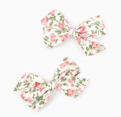 Floral bow hair clips by Molly & Rose; white 100% polyester fabric bows with printed detail on pink covered clips