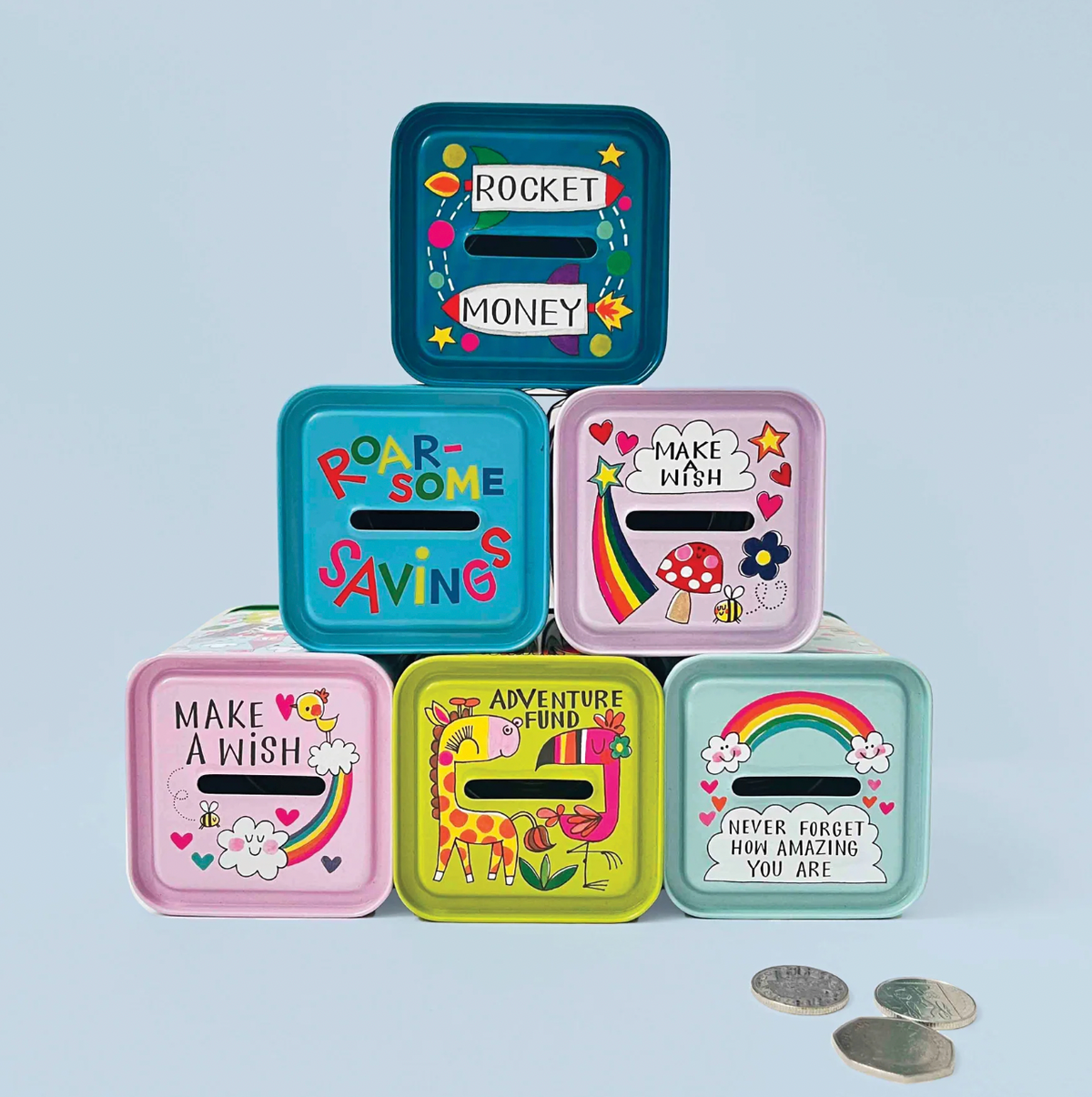Close-up of the Rachel Ellen blue dinosaur money box tin showing red and green dinosaur illustrations, speech bubbles and colourful spots