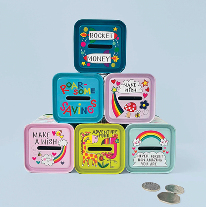 Close-up of the Rachel Ellen blue dinosaur money box tin showing red and green dinosaur illustrations, speech bubbles and colourful spots
