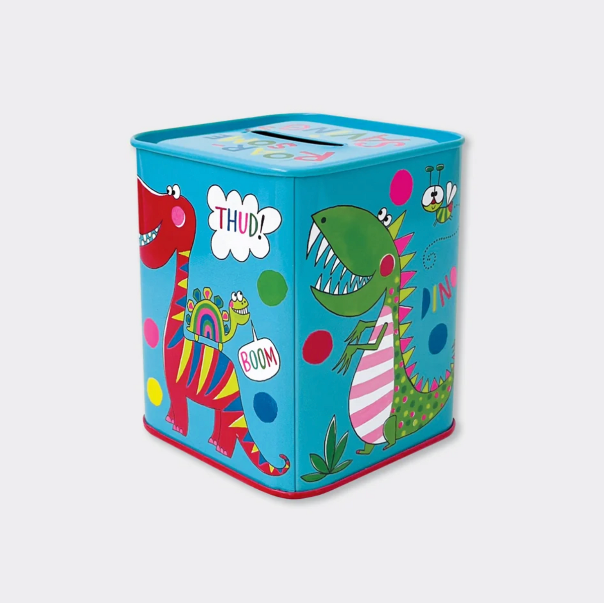 Child saving coins in a Rachel Ellen dinosaur money box, with the blue illustrated tin held in the foreground and other money boxes nearby