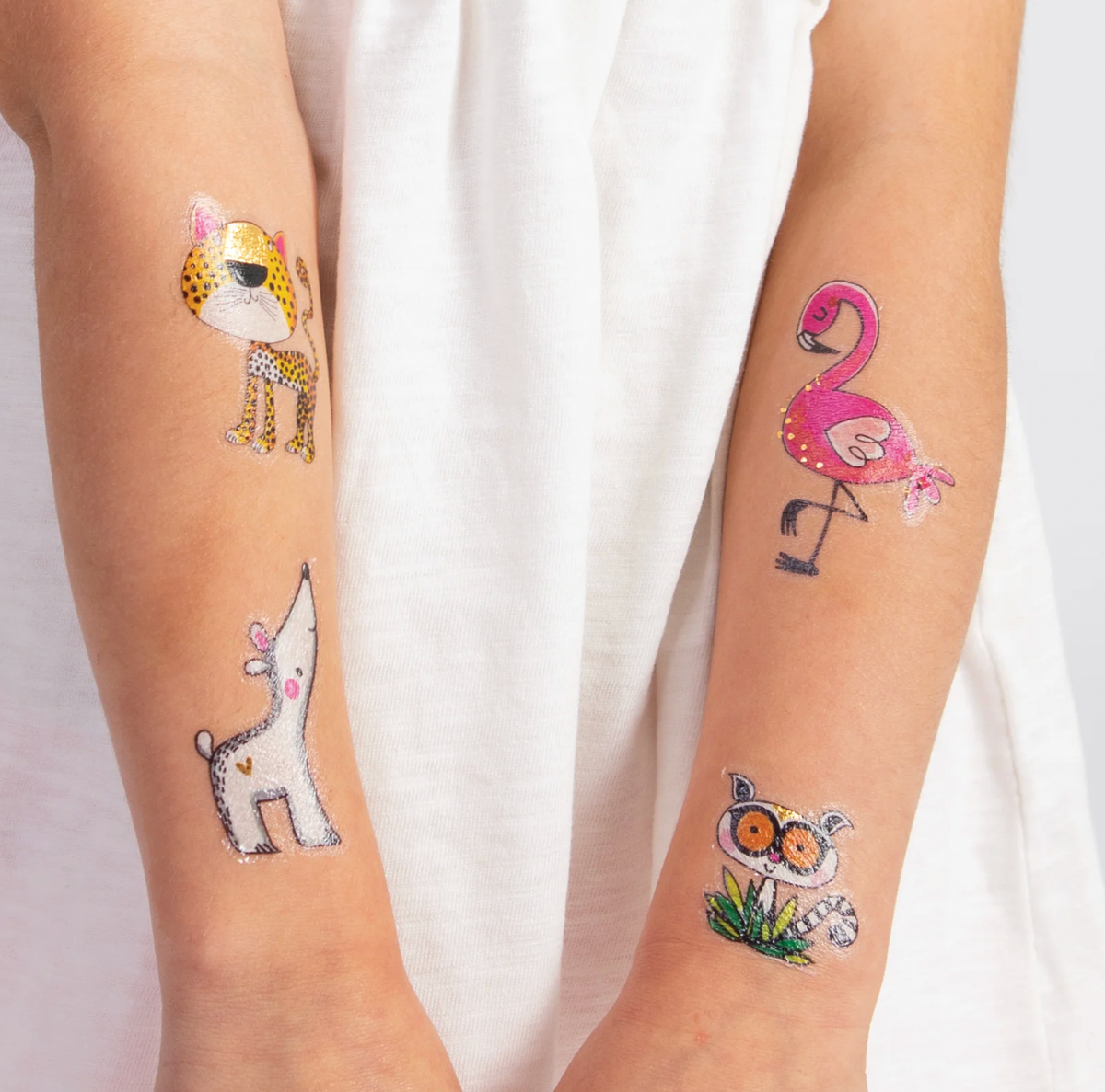 Pink flamingo temporary tattoo with gold foil detail applied to a child's forearm from the Rachel Ellen Love Our Planet collection