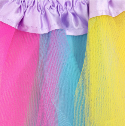 Molly & Rose unicorn dress-up accessories shown separately; gold horn aliceband has glittery ears and pastel flowers, beside shiny gold wings with elastic straps