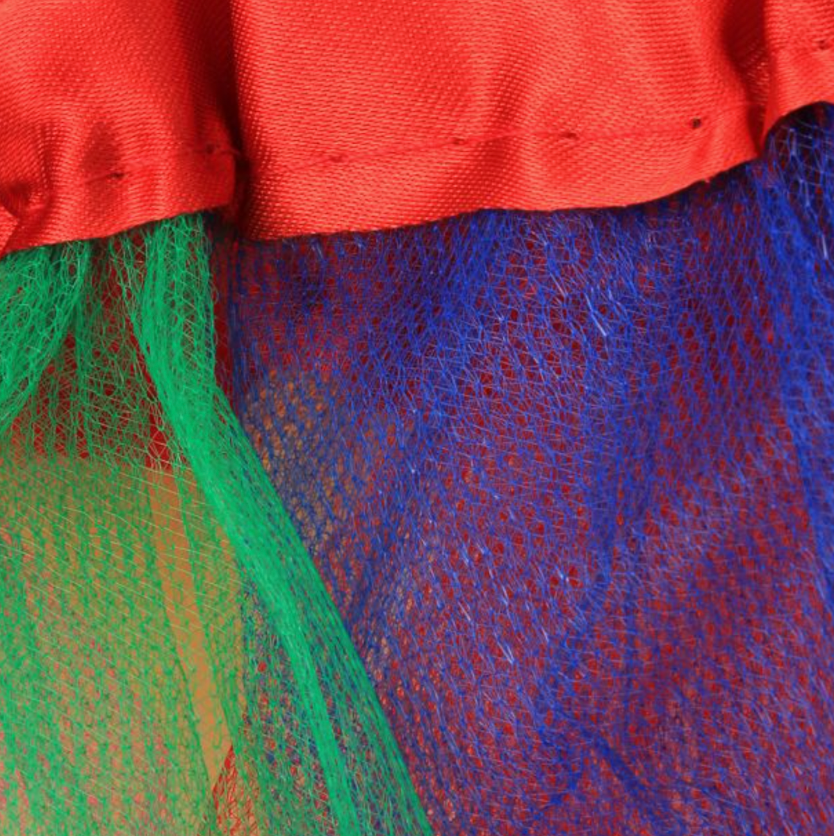 Close-up of Molly & Rose rainbow tutu fabric showing the red waistband and open net texture in green and deep blue panels