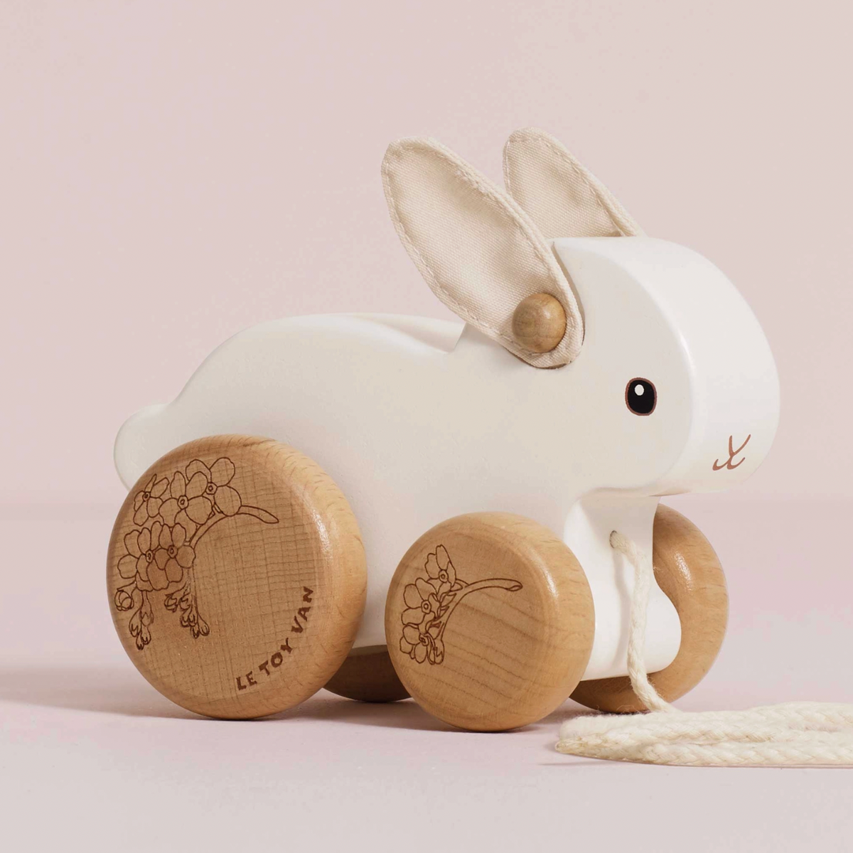Le Toy Van Pull Along Rabbit, a wooden pull-along toy with soft felt ears and a playful hopping motion for early walkers.