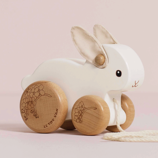 Le Toy Van Pull Along Rabbit, a wooden pull-along toy with soft felt ears and a playful hopping motion for early walkers.