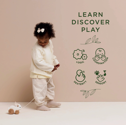 Le Toy Van wooden Pull Along Rabbit for babies and toddlers, with soft felt ears and a hopping action to support early walking play.