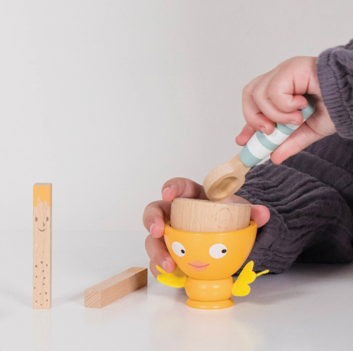 Six-piece wooden play food breakfast set from Le Toy Van, featuring a magnetic egg, two toast soldiers, wooden spoon and felt-wing egg cup.