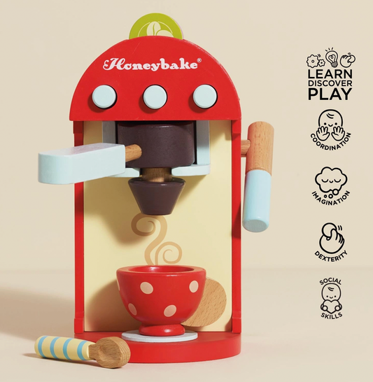 Le Toy Van Wooden Coffee Machine & Pods play-kitchen set with wooden coffee pods, removable portafilter, milk frother, painted cup and spoon.