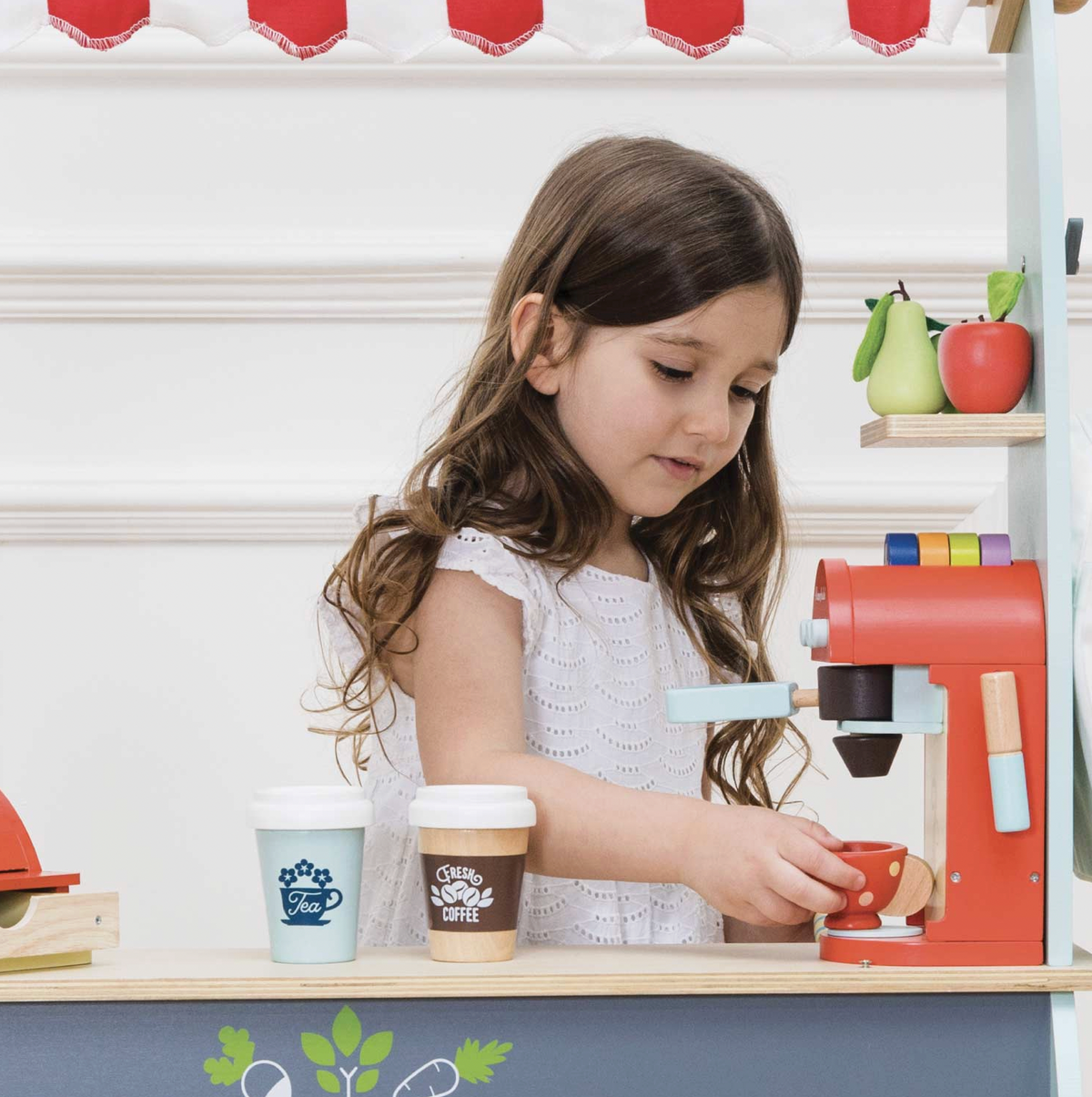 Wooden toy coffee machine by Le Toy Van, supplied with coffee pods, a removable portafilter, milk frother, painted cup and spoon.