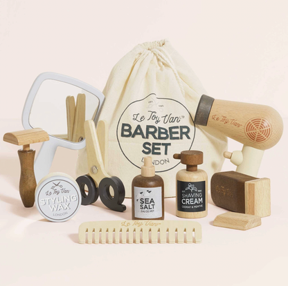Le Toy Van wooden barber set for little stylists, supplied with 12 grooming accessories and a cotton storage bag.