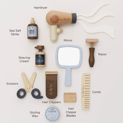 Le Toy Van pretend-play barber and hairdresser kit with 12 grooming accessories and a cotton bag for storage.