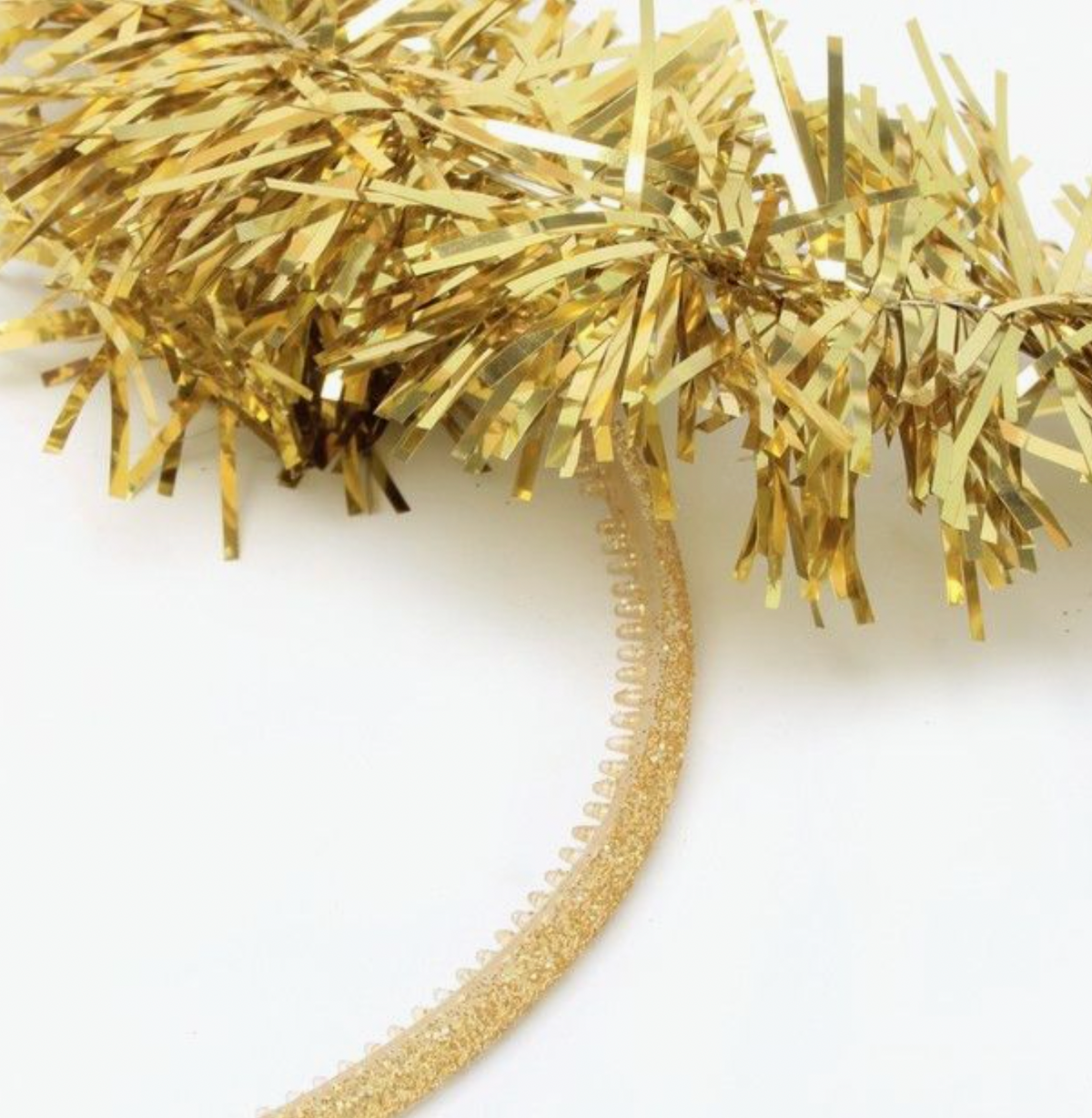 Gold tinsel halo Alice band by Molly & Rose, showing the festive gold tinsel ring raised above the slim glitter band.