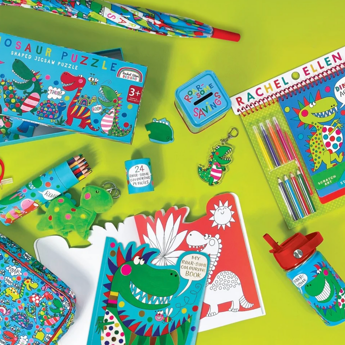 Rachel Ellen dinosaur range arranged on lime-green background: turquoise bottle with red lid at lower right, open My Roar-some Colouring Book below, Dinosaur Puzzle box marked Shaped Jigsaw Puzzle and 3+ at left, Roar-some Savings tin, keyrings, pencil tube marked 24 Roar-some Colouring Pencils, scratch-art pack and patterned case.