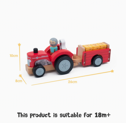 Jumini red wooden tractor and loaded trailer dimension graphic, with farmer and dog aboard and three yellow bales; yellow arrows label 26cm length, 8cm width and 10cm height, with text below reading This product is suitable for 18m+.