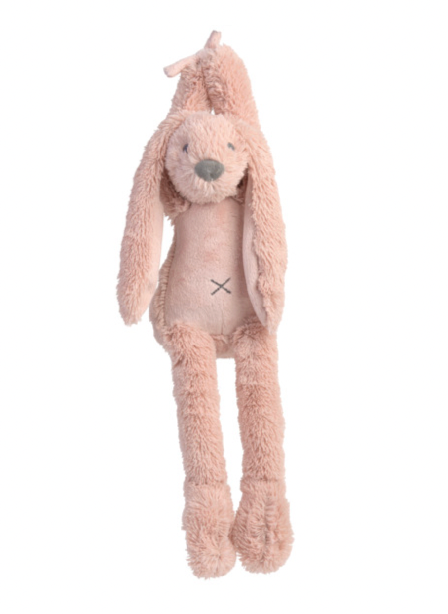 Happy Horse Musical Richie Rabbit in Old Pink hanging upright against a white background; dusty-pink textured plush head with small dark eyes and grey nose, very long floppy ears beside a smooth pink tummy panel marked with a dark stitched cross. Long narrow legs end in oversized rounded plush feet, with pink fabric ties visible above the head.