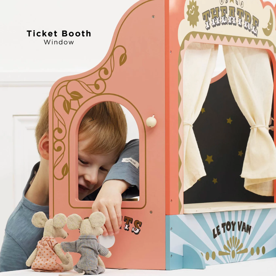 Child playing with a toy theatre set, peering through a 'Ticket Booth Window' with curtains. TABLETOP PUPPET THEATRE | LE TOY VAN