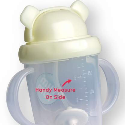 Baby sippy cup with a lid featuring bear ears, clear body with measurement markings. TIPPY CUP WITH STRAW AND FLIP TOP LEAKPROOF LID - PETE POLAR BEAR (GLOW IN THE DARK)  | TUM TUM