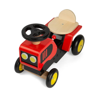 Toy car with red body, black wheels, and beige seat. TODDLER RIDE ON WOODEN TRACTOR - RED | BIGJIGS