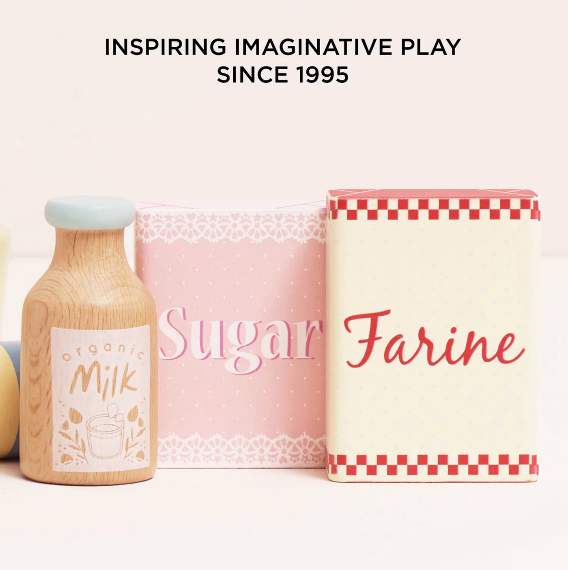 Wooden milk bottle, pink sugar container, and white flour container with text on a white background. TOY BAKERS MIXER SET AND ACCESSORIES | LE TOY VAN