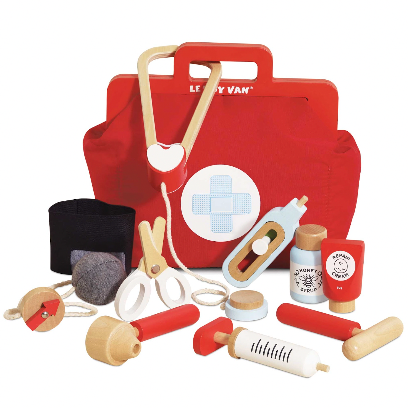 Red toy first aid kit with various medical tools on a white background. VINTAGE DOCTOR ROLEPLAY KIT | LE TOY VAN