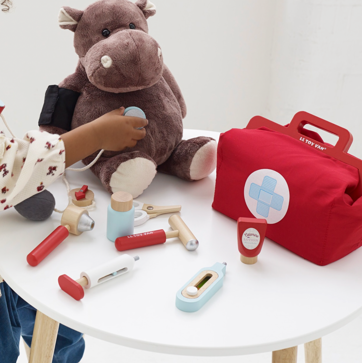 Children's toy medical set with plush hippo and red bag on a white surface. VINTAGE DOCTOR ROLEPLAY KIT | LE TOY VAN