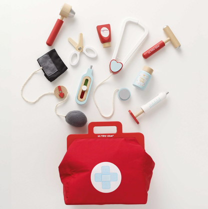 Collection of toy medical tools and a red bag with a cross symbol on a white background. VINTAGE DOCTOR ROLEPLAY KIT | LE TOY VAN