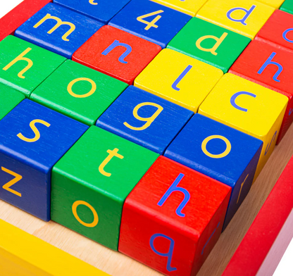 Colorful alphabet blocks on a wooden surface. WOODEN BABY MULTI-COLOUR WALKER WITH ABC & NUMBER BLOCKS | TIDLO