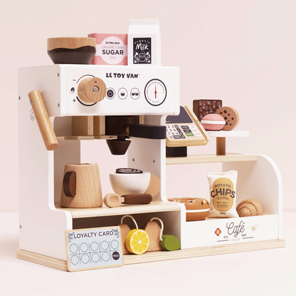 Toy coffee shop set with miniature coffee machine and items on a light pink background WOODEN BARISTA CAFE SHOP | LE TOY VAN