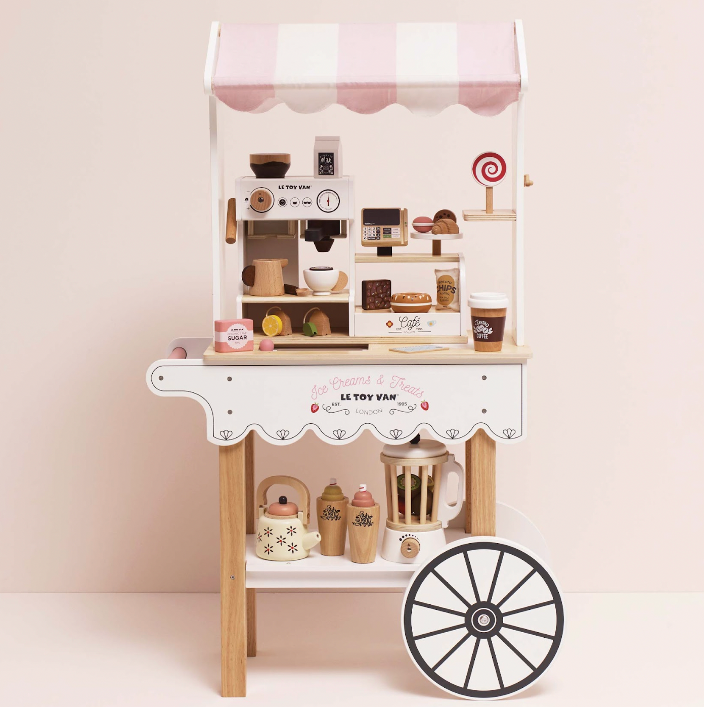 Children's play kitchen set with toy appliances and a wheel on a light pink background. WOODEN BARISTA CAFE SHOP | LE TOY VAN