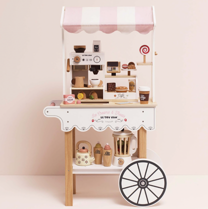 Children's play kitchen set with toy appliances and a wheel on a light pink background. WOODEN BARISTA CAFE SHOP | LE TOY VAN