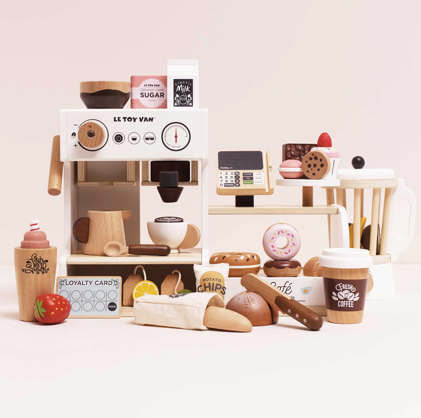 Wooden toy coffee shop set with various items on a light pink background. WOODEN BARISTA CAFE SHOP | LE TOY VAN