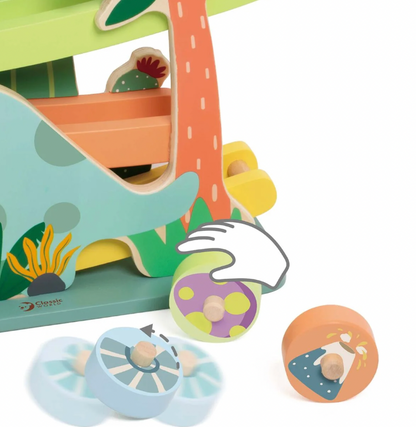 Children's wooden toy set with a slide, wheels, and colorful elements on a white background. WOODEN DINOSAUR SLIDE PLAY TOY | CLASSIC WORLD