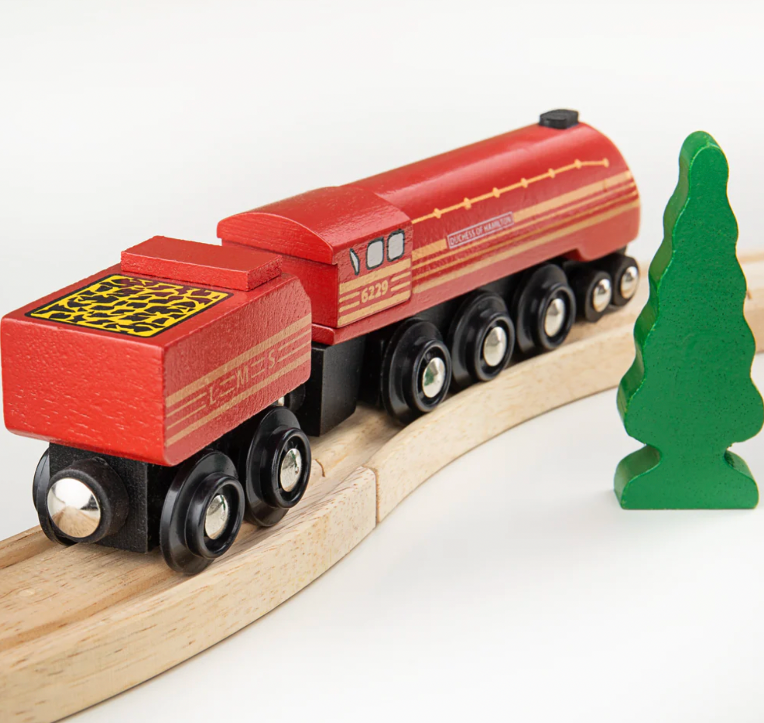 Wooden toy train set on a track with a green tree figure beside it. WOODEN HERITAGE COLLECTION DUCHESS OF HAMILTON | BIGJIGS RAIL