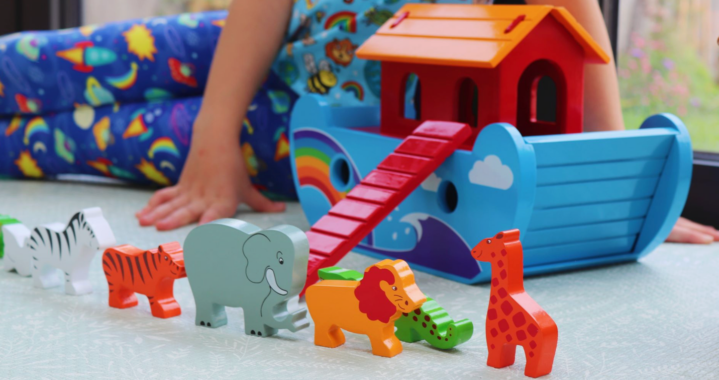 Colorful toy animals in front of a child's playhouse WOODEN RAINBOW ARK - HANDMADE & FAIR TRADE | LANKA KADE
