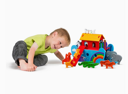 Child playing with a colorful toy Noah's Ark on a white background WOODEN RAINBOW ARK - HANDMADE & FAIR TRADE | LANKA KADE