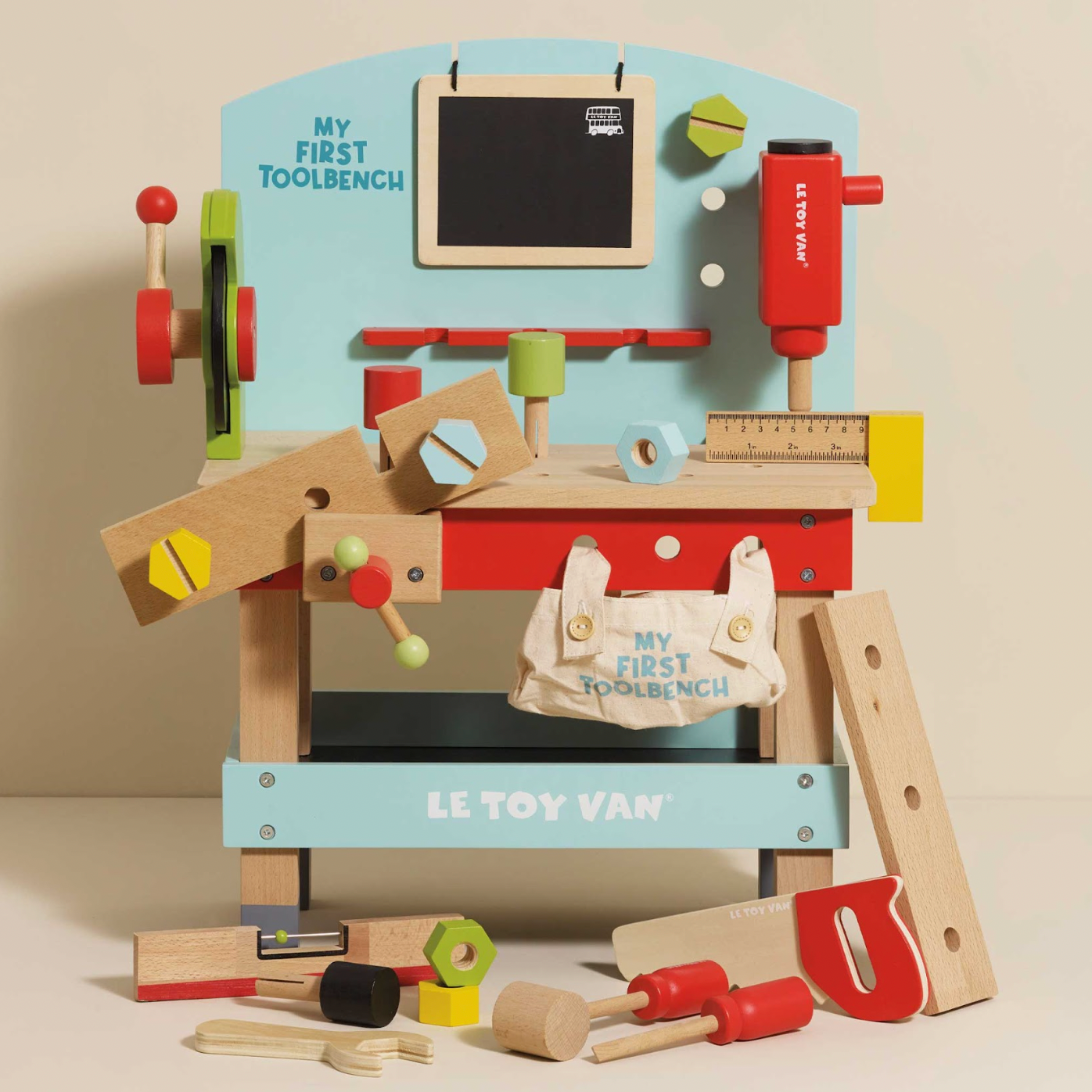 Toy workbench set with tools and accessories, featuring 'Le Toy Van' branding. WOODEN TOOL BENCH | LE TOY VAN 