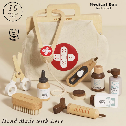 Set of baby care items with a medical bag included on a beige background. WOODEN TOY ANIMAL VET SET | LE TOY VAN