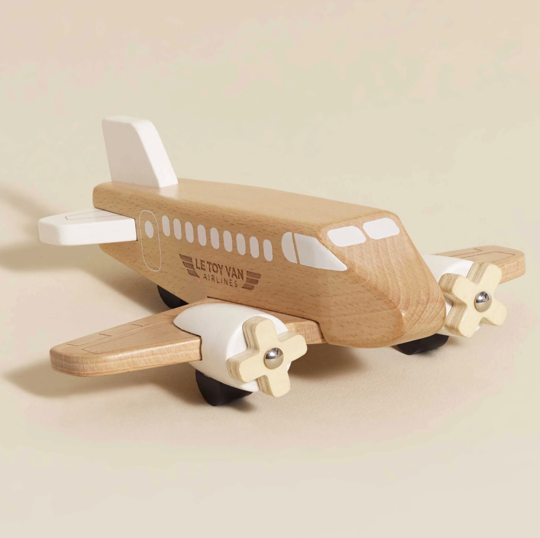 Wooden toy airplane with propellers on a beige background. WOODEN TOY PLANE | LE TOY VAN