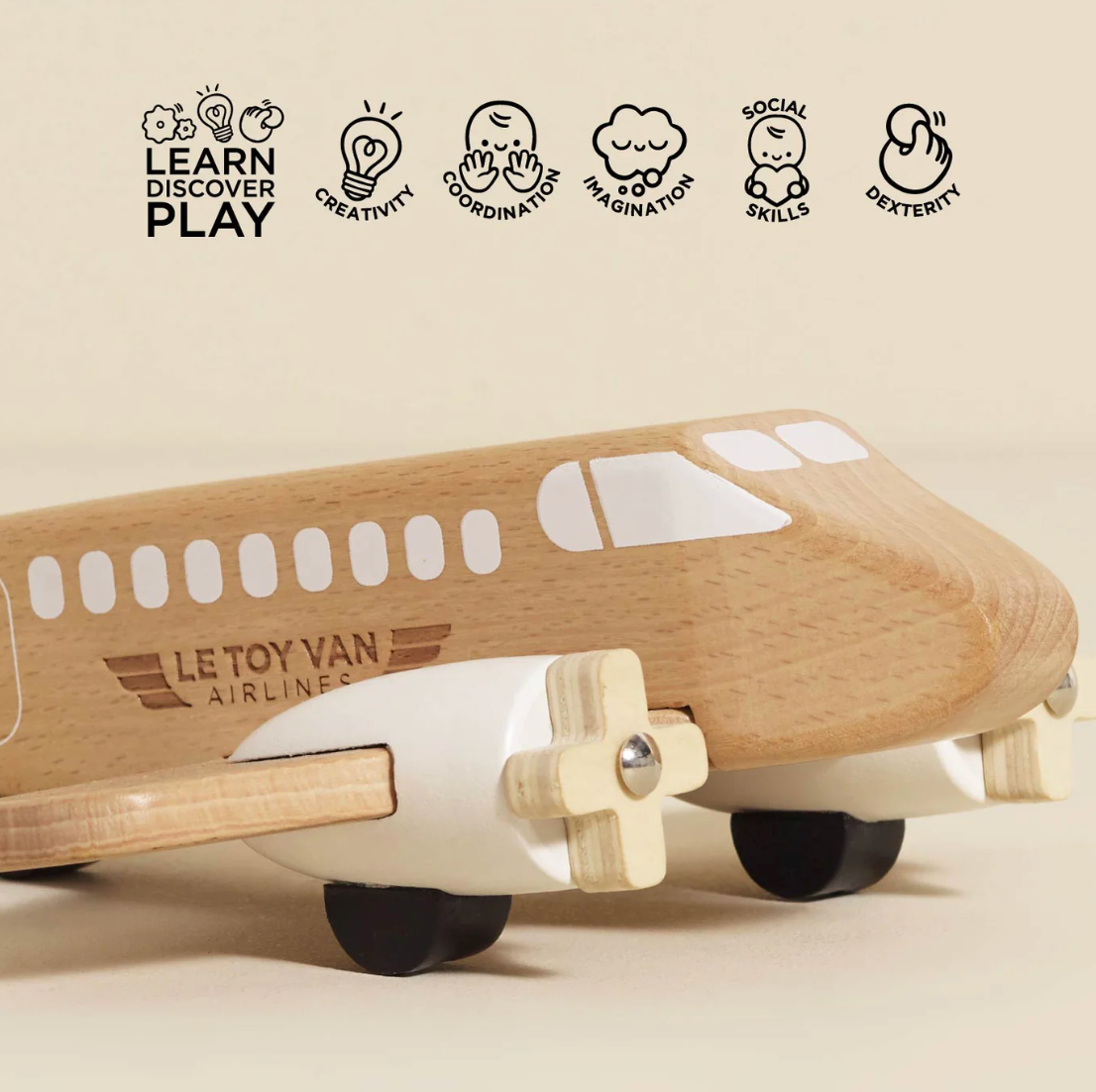 Wooden toy airplane with Le Toy Van branding on a beige background. WOODEN TOY PLANE | LE TOY VAN