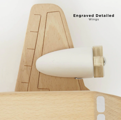 Wooden airplane model with engraved details on wings against a white background WOODEN TOY PLANE | LE TOY VAN