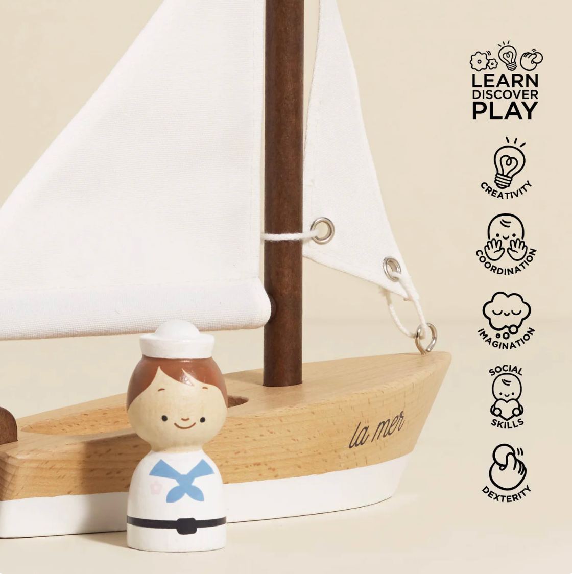Wooden toy figure with a sailboat and 'Learn Discover Play' branding WOODEN TOY SAILING BOAT & CAPTAIN | LE TOY VAN