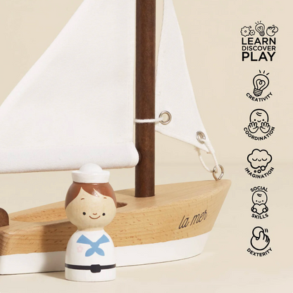 Wooden toy figure with a sailboat and 'Learn Discover Play' branding WOODEN TOY SAILING BOAT & CAPTAIN | LE TOY VAN